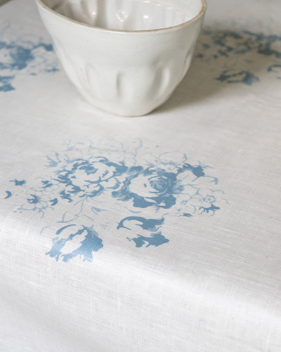 White ceramic bowl on a white surface with blue floral patterns