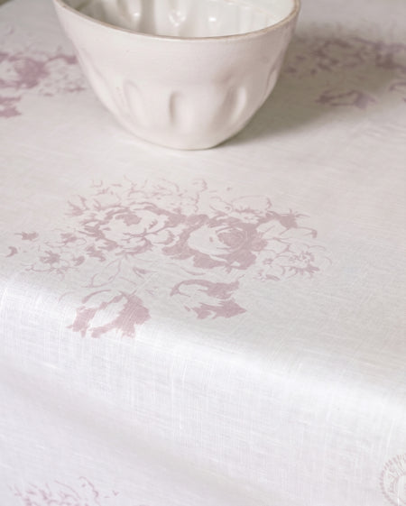 White ceramic bowl on a white surface with a subtle floral pattern