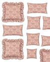 Set of pink patterned pillows with ruffled edges on a white background