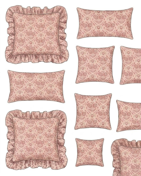 Set of pink patterned pillows with ruffled edges on a white background