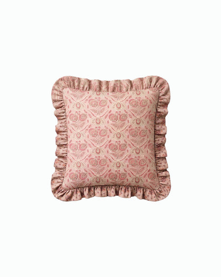 Pink patterned pillow with ruffled edges on a white background