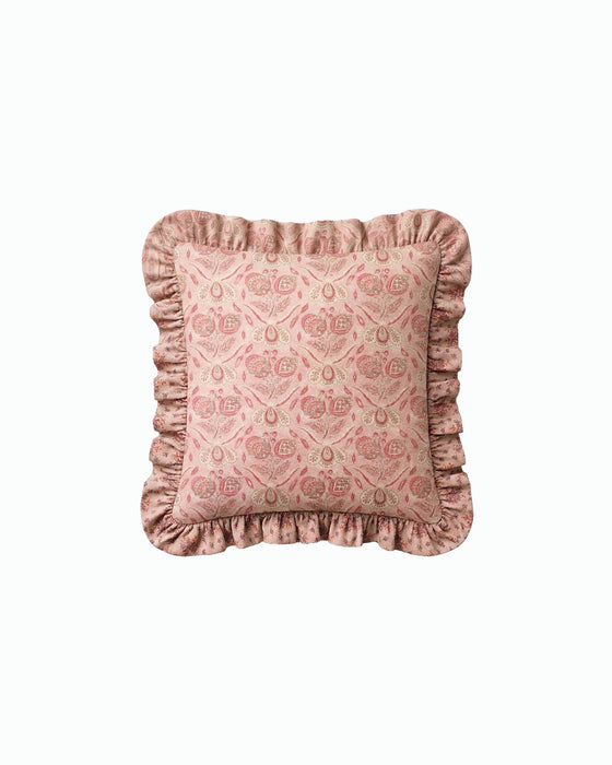 Pink patterned pillow with ruffled edges on a white background