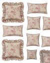 Set of floral patterned pillows with ruffled edges on a white background