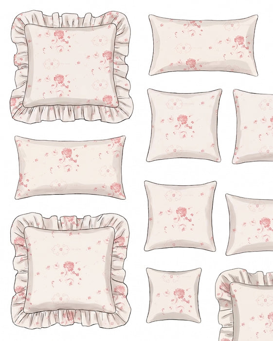 Set of decorative pillows with floral patterns and ruffled edges on a white background.