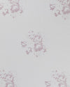 A piece of white linen fabric with a faded floral motif in a lilac color.