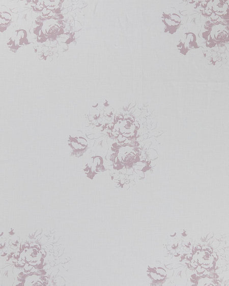 A piece of white linen fabric with a faded floral motif in a lilac color.