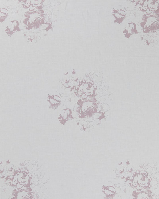 A piece of white linen fabric with a faded floral motif in a lilac color.