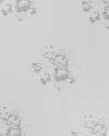 A sheet of white linen with a faded floral motif in a subtle blue tone.