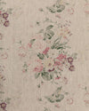 A fabric with a floral pattern in shades of purple, green, and pink on a natural linen background.