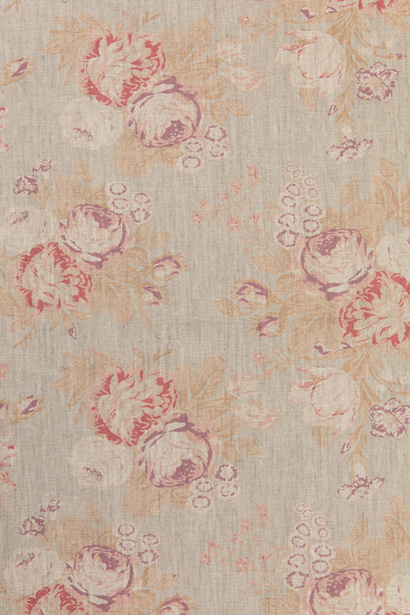 Floral patterned fabric with pink and red flowers on a beige background